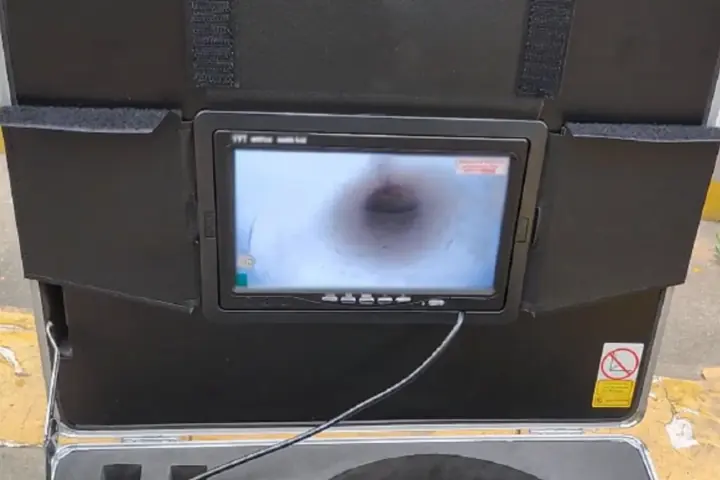 Sewer camera monitor showing the inside of a drain pipe